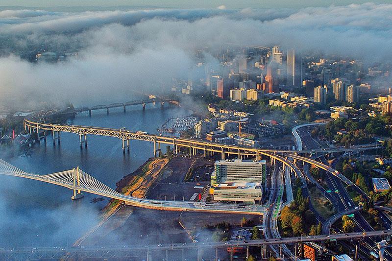 aerial of downtown 波特兰 with clouds floating over buildings and bridges